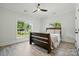 Comfortable bedroom featuring a dark wooden bed frame and large windows with a view to the yard at 167 Logan Crossing Dr, Davidson, NC 28036