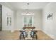 Bright dining area with a rustic wooden table, stylish stools, and direct access to the outdoor space at 167 Logan Crossing Dr, Davidson, NC 28036