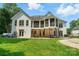 This home has a sprawling backyard with a covered patio, fire pit, and lush green landscaping at 167 Logan Crossing Dr, Davidson, NC 28036