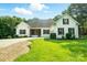 Charming single Gathering home showcasing lush green lawn, complemented by the elegance of white brick and dark shutters at 167 Logan Crossing Dr, Davidson, NC 28036