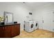 Well-equipped laundry room with modern washer and dryer, plenty of cabinet space, and stylish accents at 167 Logan Crossing Dr, Davidson, NC 28036