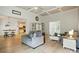Spacious living room with a cozy sofa, decorative shelving unit, and seamless access to the adjacent kitchen at 167 Logan Crossing Dr, Davidson, NC 28036