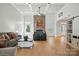 Open-concept living room boasts a stone fireplace, large windows, and elegant hardwood floors, perfect for entertaining at 167 Logan Crossing Dr, Davidson, NC 28036