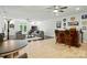 Spacious living room featuring hardwood floors, comfortable seating, a bar, and natural light at 167 Logan Crossing Dr, Davidson, NC 28036
