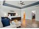 Spacious main bedroom featuring a tray ceiling, a king-size bed, a seating area and a walk-in closet at 167 Logan Crossing Dr, Davidson, NC 28036
