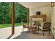 Relaxing covered patio with an outdoor fireplace and elegant furniture overlooking the backyard at 167 Logan Crossing Dr, Davidson, NC 28036