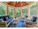 Bright screened-in porch with comfortable seating, a patterned rug, and views of the surrounding landscape at 167 Logan Crossing Dr, Davidson, NC 28036