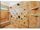 Custom tiled walk-in shower with multiple shower heads, niches, and bench seating, offers spa like experience at 167 Logan Crossing Dr, Davidson, NC 28036