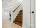 Staircase with wooden steps and handrail, leading to an office area with natural light and minimalist decor at 167 Logan Crossing Dr, Davidson, NC 28036