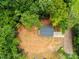 Aerial view of home with dark gray roof on large lot surrounded by lush greenery at 1723 Rhyneland Cir, Gastonia, NC 28054