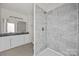 Stylish bathroom featuring gray tiled shower, gray granite counters, and modern fixtures at 1723 Rhyneland Cir, Gastonia, NC 28054