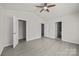 A bedroom with a ceiling fan, neutral walls, light grey flooring and access to the closet at 1723 Rhyneland Cir, Gastonia, NC 28054