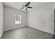 A bedroom with a ceiling fan, one window, neutral walls and light grey flooring at 1723 Rhyneland Cir, Gastonia, NC 28054