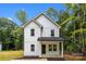 Charming two-story home with white vertical siding, black roof, and inviting front porch at 1723 Rhyneland Cir, Gastonia, NC 28054