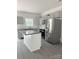 Modern kitchen with gray cabinets, stainless steel appliances, granite counters, and gray wood-look floors at 1723 Rhyneland Cir, Gastonia, NC 28054