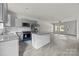 Open kitchen and living space with gray cabinets, stainless appliances, and granite island at 1723 Rhyneland Cir, Gastonia, NC 28054