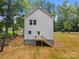 Rear view of new home featuring white siding, professionally installed windows and a wooden staircase at 1723 Rhyneland Cir, Gastonia, NC 28054
