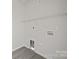 A walk-in closet with white walls, light grey floors and a white wire shelf at 1723 Rhyneland Cir, Gastonia, NC 28054