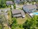 Aerial view of a two-story home with a fenced backyard, awning, pool, and professional landscaping at 1812 Sutter Creek Dr, Waxhaw, NC 28173
