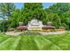 View of the Tuscany community entrance with a decorative sign, well-maintained landscaping, and lush greenery at 1812 Sutter Creek Dr, Waxhaw, NC 28173