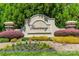 Entrance sign to the Tuscany neighborhood, featuring lush landscaping and a decorative stone monument at 1812 Sutter Creek Dr, Waxhaw, NC 28173