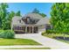 Charming home featuring mature landscaping, a gray and stone facade, and a spacious driveway at 1812 Sutter Creek Dr, Waxhaw, NC 28173