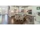 Bright kitchen features white cabinetry, stainless steel appliances, granite countertops, and dark hardwood floors at 1812 Sutter Creek Dr, Waxhaw, NC 28173