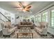 Spacious living room with hardwood floors, large windows, and an open floor plan at 1812 Sutter Creek Dr, Waxhaw, NC 28173