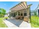 Inviting outdoor patio with awning, wicker furniture, and well-maintained landscaping at 1812 Sutter Creek Dr, Waxhaw, NC 28173