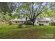 Large backyard with a deck, screened in porch, play area, and plenty of space to enjoy at 1821 Bonnie Ln, Charlotte, NC 28213