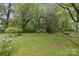 Lush backyard with mature trees and flowering shrubs at 1821 Bonnie Ln, Charlotte, NC 28213