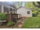 Well-maintained backyard features a screened-in porch, deck, and stepping stone walkway at 1821 Bonnie Ln, Charlotte, NC 28213