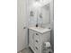 Bathroom with blue walls, a white vanity and sink, a mirror and vanity lights at 1821 Bonnie Ln, Charlotte, NC 28213