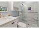 This updated bathroom features a tiled shower, hexagon tile floors, and white cabinets at 1821 Bonnie Ln, Charlotte, NC 28213