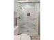 Updated bathroom showcases a beautifully tiled shower with glass door and modern fixtures at 1821 Bonnie Ln, Charlotte, NC 28213