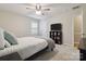 Bedroom features a ceiling fan, a window letting in natural light, and carpeted floors at 1821 Bonnie Ln, Charlotte, NC 28213