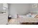 Cozy bedroom features neutral walls, wood floors, and a bright window at 1821 Bonnie Ln, Charlotte, NC 28213