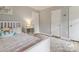 Bright bedroom with hardwood floors features three white doors and cozy decor at 1821 Bonnie Ln, Charlotte, NC 28213