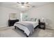 This carpeted bedroom features a ceiling fan and dark wood furnishings at 1821 Bonnie Ln, Charlotte, NC 28213