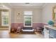 Bright bonus room features wood floors, neutral walls, and natural light from a window overlooking lush greenery at 1821 Bonnie Ln, Charlotte, NC 28213