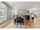 Dining room with wood floors, track lighting, dining table, and a view of the kitchen and living room at 1821 Bonnie Ln, Charlotte, NC 28213