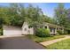 Charming home featuring a detached two-car garage and a well-maintained front yard at 1821 Bonnie Ln, Charlotte, NC 28213