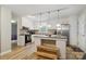 Bright kitchen with stainless steel appliances, a center island, and hardwood floors at 1821 Bonnie Ln, Charlotte, NC 28213