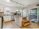 Bright kitchen with stainless steel appliances, a center island, and hardwood floors at 1821 Bonnie Ln, Charlotte, NC 28213