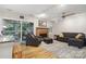 Cozy living room featuring a brick fireplace and a sliding door to a screened porch at 1821 Bonnie Ln, Charlotte, NC 28213