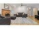 Cozy living room with a brick fireplace, ceiling fan, and hardwood floors at 1821 Bonnie Ln, Charlotte, NC 28213