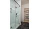 Modern bathroom featuring a glass-enclosed shower with white subway tiles, and an open closet area at 2011 Hamorton Pl, Charlotte, NC 28205