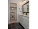 Bright bathroom features double sinks, a large mirror, and an open closet providing ample storage at 2011 Hamorton Pl, Charlotte, NC 28205