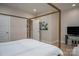 This bedroom features neutral paint, wood floors, and a view into the bathroom at 2011 Hamorton Pl, Charlotte, NC 28205