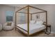 Bedroom features a four-poster bed and chair with wood flooring and natural light at 2011 Hamorton Pl, Charlotte, NC 28205